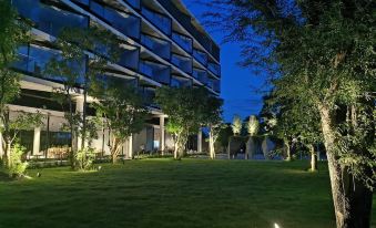 The hotel building is surrounded by greenery at night at Livist Resort Phetchabun