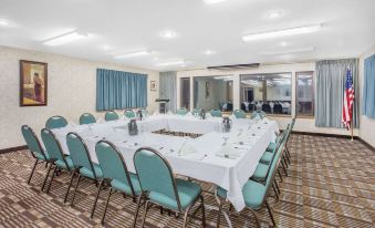 a conference room set up for a meeting with chairs arranged in a semicircle around a table at Ramada by Wyndham Hancock Waterfront