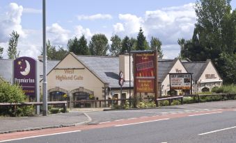 "a brick building with a sign that reads "" hotel highland glen "" prominently displayed on the front of the building" at Premier Inn Glasgow (Milngavie)