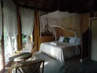 Romantic bungalow surrounded by trees.