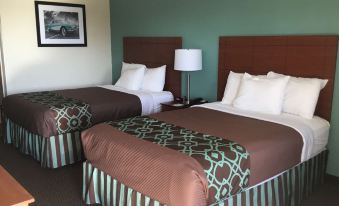 a hotel room with two beds , each made with brown and green bedding , flanked by nightstands and lamps at SureStay Hotel by Best Western Bowling Green North