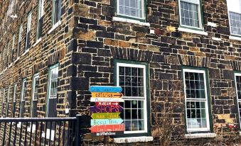 a snowy day in a village setting , with a group of colorful signs attached to the side of a building at The Inn at Stone Mill