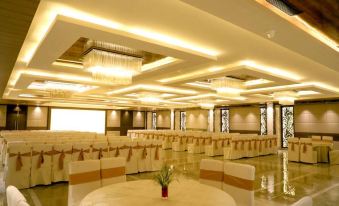 a large banquet hall with tables and chairs set up for a formal event , possibly a wedding reception at Ritz Resort