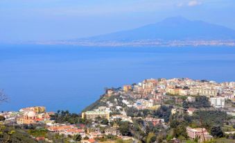 a scenic view of a city by the sea with mountains in the background , providing a panoramic view at Grand Hotel Moon Valley