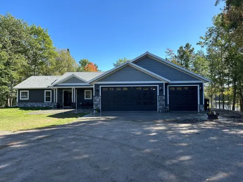 BEAUTIFUL lake front home with a private beach, dock and large yard