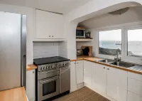 Spacious light cosy beach front house with balcony overlooking the sea