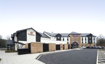 "a long row of buildings with a sign that says "" buckstone "" and a street view of the street" at Premier Inn Ware