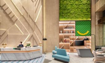 The lobby features wood paneling and an intriguing design on the wall at Holiday Inn Shanghai Nanjing Road