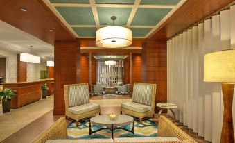 a hotel lobby with two chairs , a coffee table , and a rug on the floor at Marriott's Oceana Palms