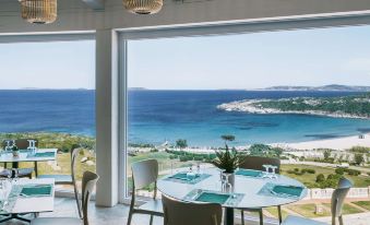 a dining room with tables and chairs arranged for a group of people to enjoy a meal at MClub Marmorata