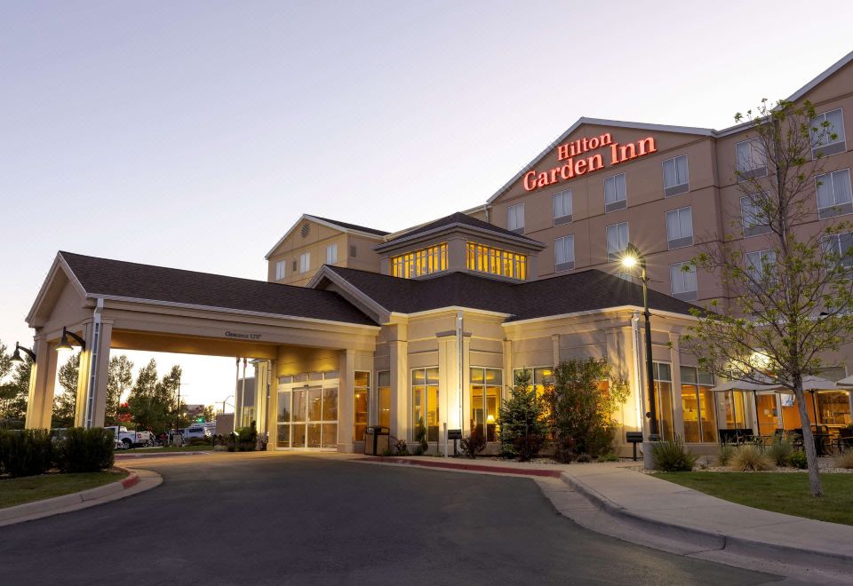 a hilton garden inn hotel with its large sign and its entrance lit up at dusk at Hilton Garden Inn Laramie