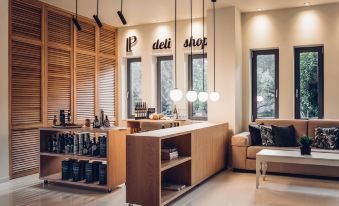 "a modern store with wooden furniture , large windows , and a shelf of products , along with the logo "" deli shop "" hanging above the counter" at Libyan Princess