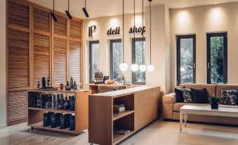 a modern coffee shop with a wooden counter , shelves of coffee beans , and a couch at Libyan Princess