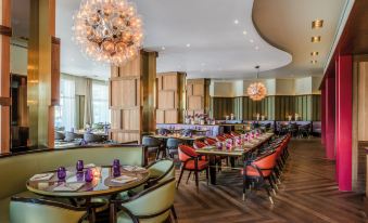 a large dining room with multiple tables and chairs arranged for a group of people to enjoy a meal together at Vila Vita Parc