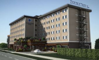 "a large hotel with a beige exterior and the name "" double tree "" on top of it" at Doubletree by Hilton Brescia