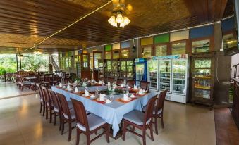 a large dining room with a long table covered in blue tablecloths , surrounded by chairs at Nakakiri Resort & Spa