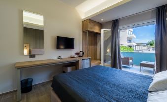 a modern bedroom with a large bed , a television , and a balcony overlooking the city at Paradise Resort