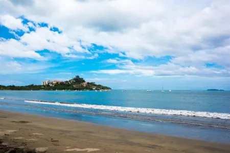 Beachfront Condo with Warm, Rustic Interiors & Direct Access to Playa Flamingo