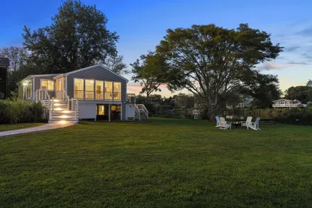 Stunning waterfront home with big yard & dock! Voted #1 rental in all of RI!