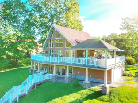 Lakehouse with covered dock, slide, and outdoor kitchen! Close to I-75, trails.
