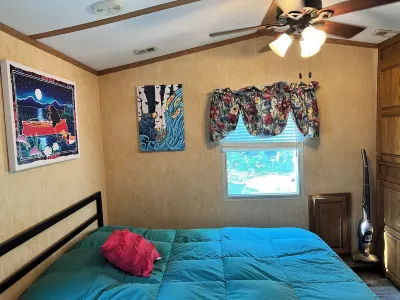 Parkmodel cabin w screened porch in campground on bike trail.