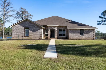Enjoy this waterfront home with a pool, dock, and Blue Angels! Bring your boat!