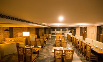 a large dining room with wooden tables and chairs arranged for a group of people to enjoy a meal together at The River Front Resort