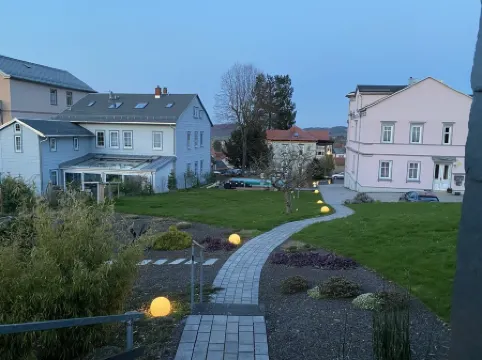 Vacation cottage garden view directly at the forest & spa gardens