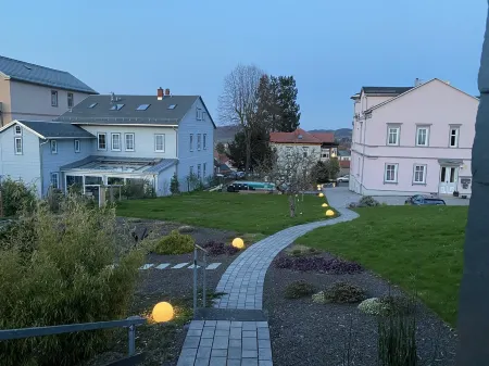 Vacation cottage garden view directly at the forest & spa gardens