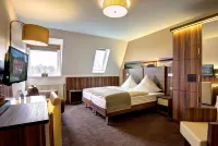 Hotel am Badepark Отели в г. Вифельштеде