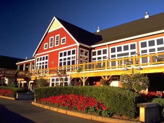 a large red and yellow house with a flower bed in front of it , creating a colorful and inviting atmosphere at Homestead Resort