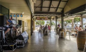 a large , open room with a row of chairs and a band playing on a stage at Streaky Bay Hotel Motel