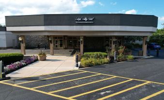 the entrance to a hotel with a large black building and yellow lines on the ground at SureStay Plus Hotel by Best Western Lehigh Valley
