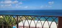 Caribbean Breeze Condo - hilltop breezes, views, convenience to beach & more!