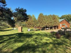 Log Cabin house on 10.5 acers of wooded land. Accommodates 20 plus guest.