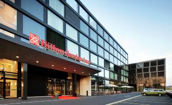 "a modern hotel building with a red sign that says "" hilton garden inn "" in front of it" at Hilton Garden Inn Zurich Limmattal