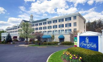 an exterior view of a fairfield inn hotel with a large building and a garden in the foreground at Somerset Hills Hotel, Tapestry Collection by Hilton