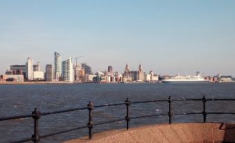 a view of the city skyline across the water with a large cruise ship in the foreground at Guest House