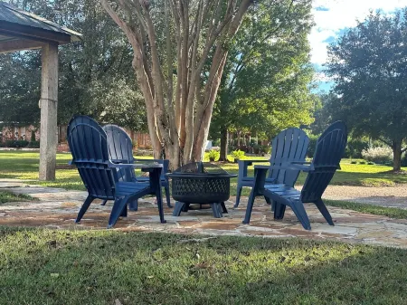 Cozy Cabin setting behind a 1 1/2 acre pond that is lined with Cypress Trees.
