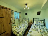 A Quaint Grade 11 Listed Detached Stone Cottage In Lower Slaughter with parking.