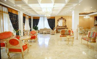 a large , elegant room with multiple couches and chairs arranged in various positions , creating a cozy and inviting atmosphere at Hotel Empire Albania