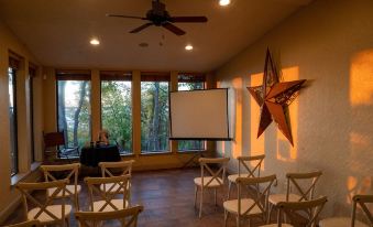 a room with a projector screen and chairs set up for an event , possibly a meeting or presentation at Lone Star Lodge and Marina