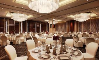 a large , elegant banquet hall with multiple tables set for a formal dinner , complete with white tablecloths and chairs at Radisson Blu Gorakhpur