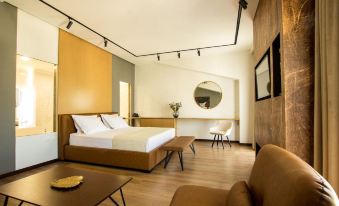 a modern hotel room with wooden floors , white walls , and a large bed , along with various furniture pieces at Hotel Fantasy