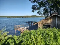Cozy waterfront log cottage with huge outdoor living area.