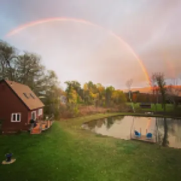 Home with a spring-fed pond and mountain view.