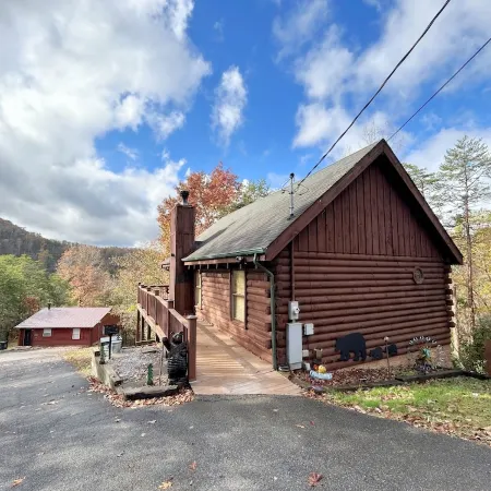 Honeymoon Log Cabin with Heart Shaped Whirlpool Tub & Hot Tub on Covered Porch