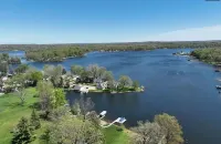 2-bedroom house on Strawberry Lake in Pinckney, MI with hot tub, WiFi.