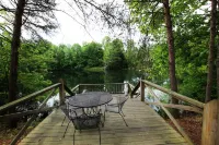 This charming  cozy cottage has a private hot tub, deck for fishing.