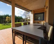 Villa in the mountains in front of a lake.